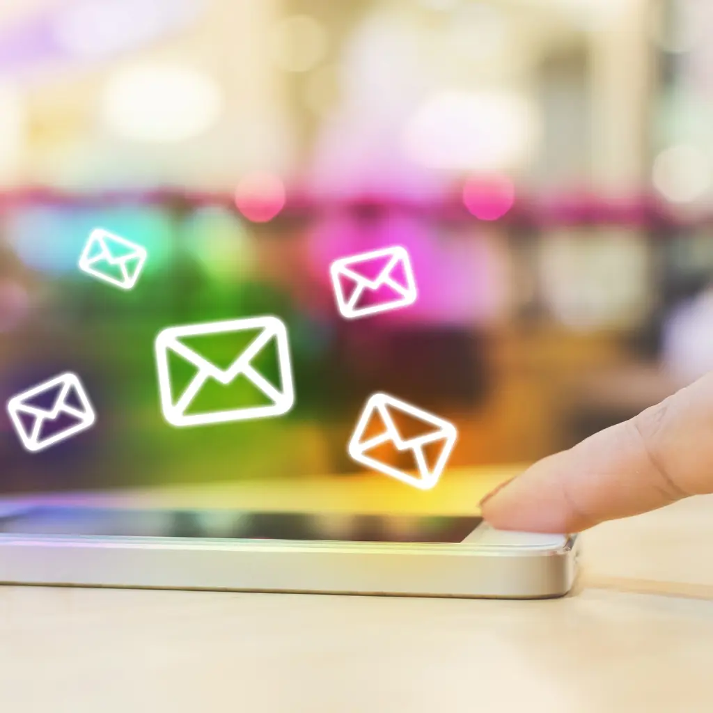 Email icons floating above a smartphone screen, representing automated email flows.
